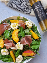 white balsamic vinegar bottle with salad